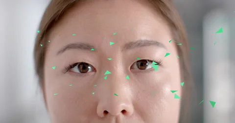 Model closing eyes while green triangles appearing and swirling revealing Stock Footage 314735010
