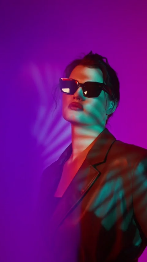 Model in coat and sunglasses posing in studio - Plus size. Stock Footage 323974545