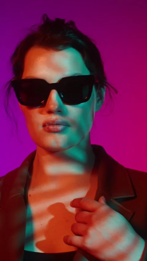 Model in coat and sunglasses posing in studio - Plus size. Stock Footage 323974615