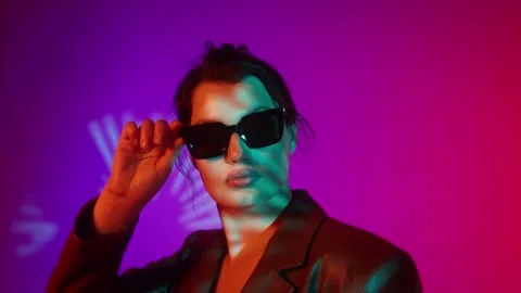Model in coat and sunglasses posing in studio - Plus size. Stock Footage 323974783