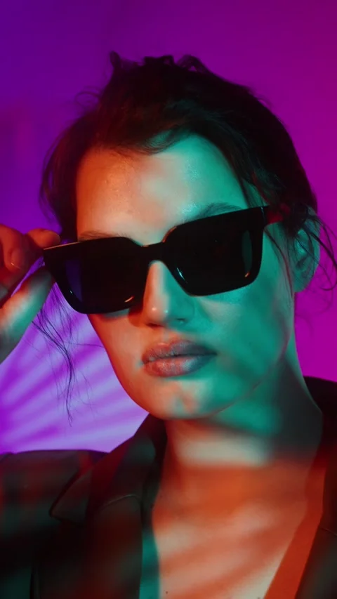 Model in coat and sunglasses posing in studio - Plus size. Stock Footage 323975484