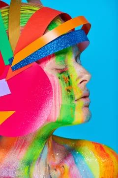 Model with colorful abstract makeup in multicolored helmet Stock Photos