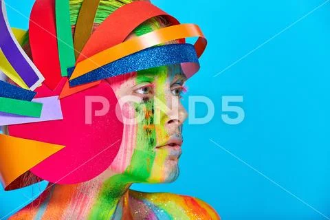 Model with colorful abstract makeup in multicolored helmet Stock Photos