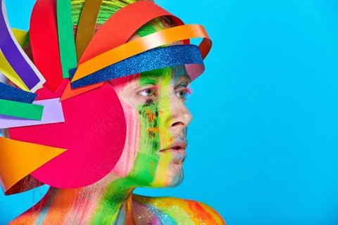Model with colorful abstract makeup in multicolored helmet Stock Photos