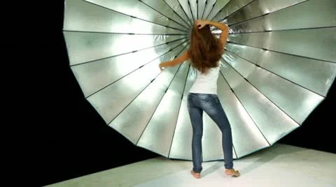 Model dances in front of reflector in photo studio Stock Footage 10568216