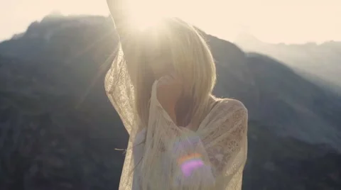 A model is dancing on the bright sunshine in the mountains Stock Footage 66486653