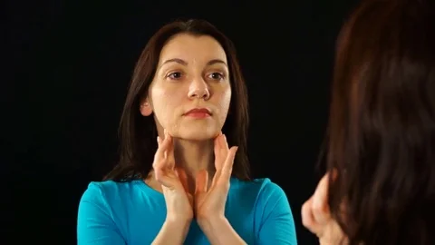 Model on a dark background with a glass of red wine looks in the mirror. Stock-Footage 74723589