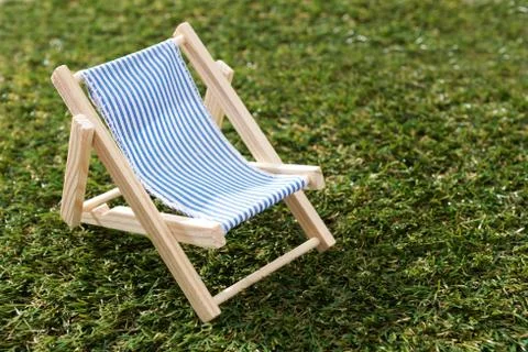 Model Deck Chair On Grass Foto stock