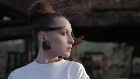 Model with designer earrings stands half face slow motion Stock Footage 117887218