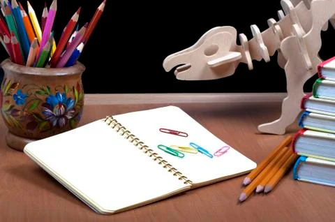 Model of dinosaur, school board and pile books, notebook Stock Photos