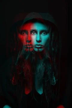 Model with dreadlocks hiding under hood studio portrait in RGB color split .. Stock Photos
