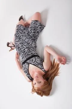 Model in a dress lying in a studio Stock Photos