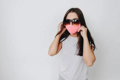The model is dressed in a protective stylish handmade mask, large sunglasses  Stock Photos