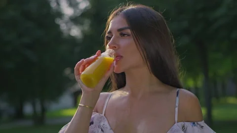 The model is drinking a juice Stock Footage 156509027