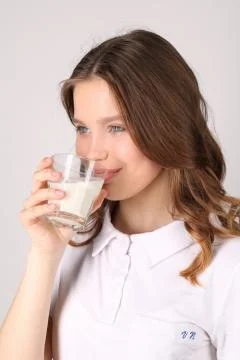 Model drinking milk. Close up. White background Stock Photos