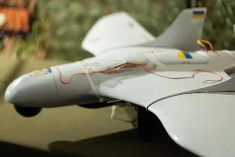 Model drone with Ukrainian flag colors displayed on a table in a well-lit e.. Stock Photos