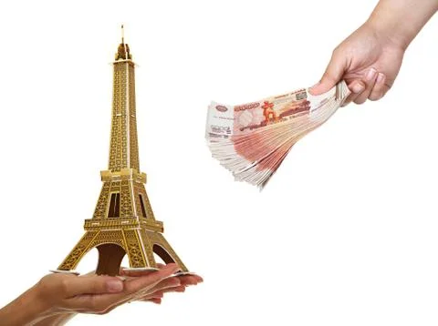 Model Eiffel Tower and a pack of five thousandth of notes in wom 스톡 사진