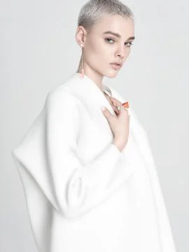 Model with elegant accessories touching jacket Stock Photos