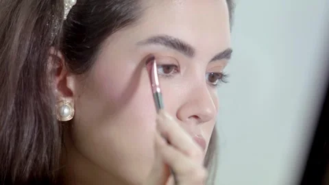 Model enhances her eyes, creating style and look that complements her Stock Footage 262614481