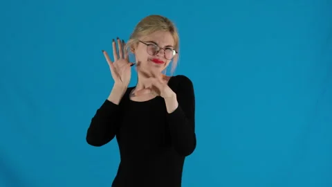 Model expresses speec with gestures holding other hand over ear Video stock 306471296