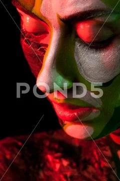 Model With Extreme Make Up In Red And Green Studio Light
