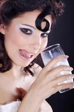 Model with fancy make up drinking milk Stock Photos