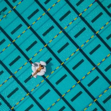 Model on Floaty in Swimming Pool Stock Photos