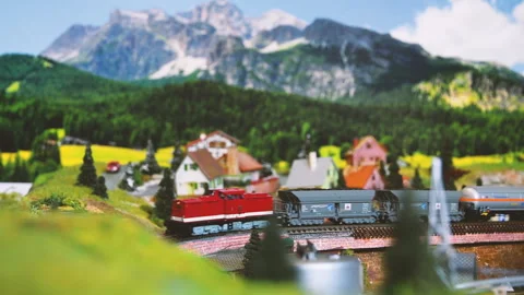 Model freight train moving on a mountain ambientation. Model railway. Stock Footage 260808939