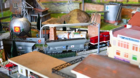 Model of a freight train passing near a refinery. Stock Footage 260806825