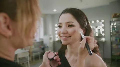 A MODEL girl is PREPARING for a Video Shoot of an ad for a Magazine, a Happy Video stock 132446515