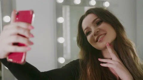 A MODEL girl is PREPARING for a Video Shoot of an ad for a Magazine, a Happy Video stock 132447221
