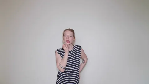 Model girl thinking and playing with lips in studio Видео 73539930