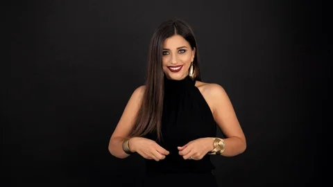 Model girl throws up multi-colored confetti on a black background 스톡 동영상 116747580