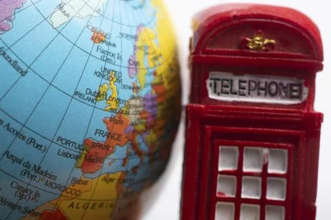 Model globe with a British telephone booth in view Stock Photos