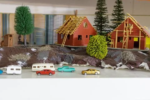 Model with a group of different small scale models of cars and caravan 스톡 사진