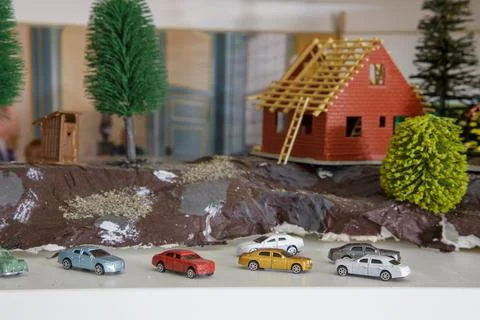 Model with group of different small scale car models 스톡 사진