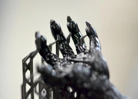 Model of hand printed 3D printer from black rubber close-up. Part object created Stock Photos