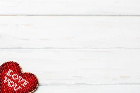 The model hart shape red color inside lay down on white wooden surface. Copy Stock Photos