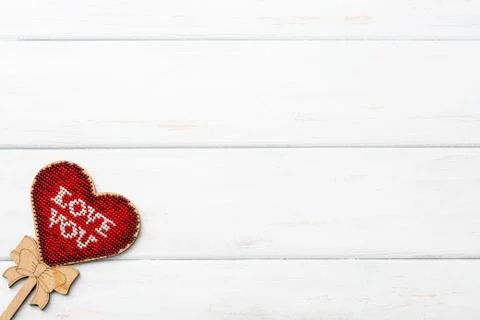 The model hart shape red color inside lay down on white wooden surface. Copy Stock Photos