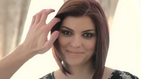 Model has hair fixed looks at camera and smiles Stock Footage 43977614