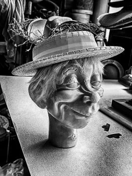 Model Head On Table In A Hat Factory In Black And White Stock Photos