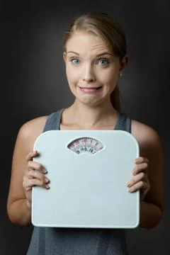 Model holding scales Stock Photos
