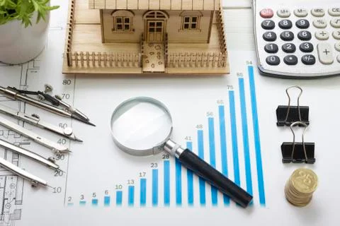 Model house, construction plan for  building, magnifying glass, divider compass Photos