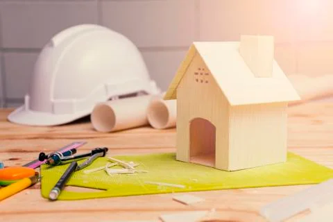 The model house is placed with a floor plan on the engineer's to design a par Stock Photos