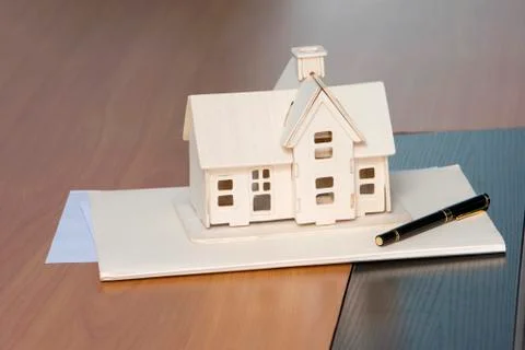 Model house placed on a folder Stock Photos