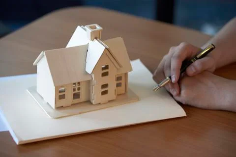 Model house placed on a folder Stock Photos