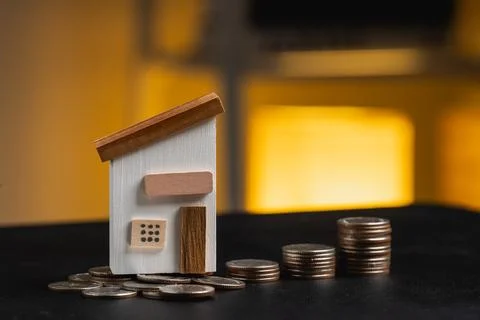 Model house on stack of coins representing finance, real estate investment,.. Stock Photos