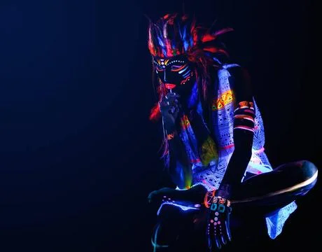 Model in image of Native american with neon makeup, which made of fluoresc... Stock Photos
