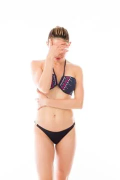 Model isolated on plain background ashamed hiding face in hand Stock Photos