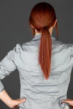 Model isolated on plain background back hands on hips Stock Photos